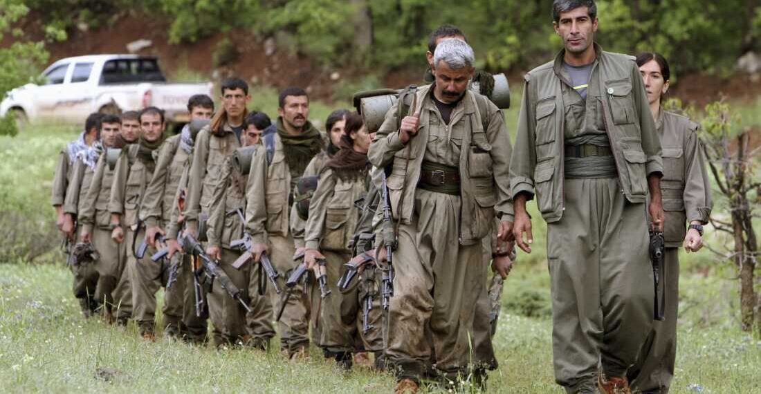 FILE - A group of armed Kurdish fighters from the Kurdistan Workers Party (PKK) enter northern Iraq in the Heror area, northeast of Dahuk, 260 miles (430 kilometers) northwest of Baghdad, Iraq, May 14, 2013. (AP Photo/Ceerwan Aziz, File)