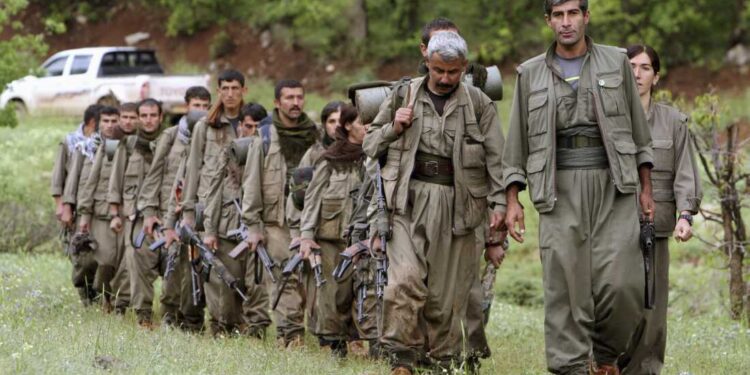 FILE - A group of armed Kurdish fighters from the Kurdistan Workers Party (PKK) enter northern Iraq in the Heror area, northeast of Dahuk, 260 miles (430 kilometers) northwest of Baghdad, Iraq, May 14, 2013. (AP Photo/Ceerwan Aziz, File)